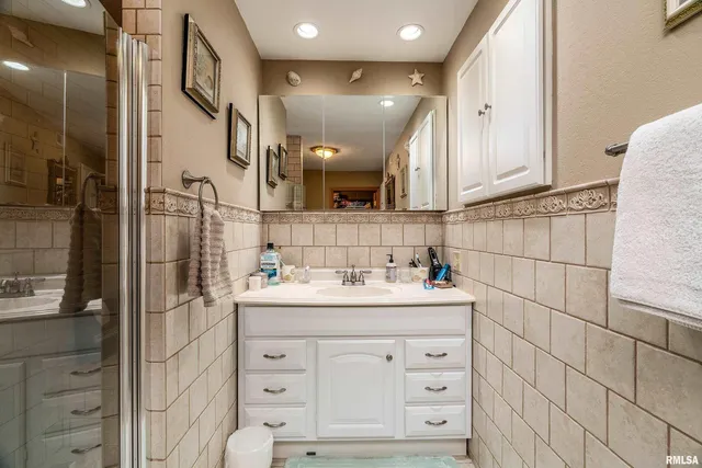 a front view of a house with a large trees