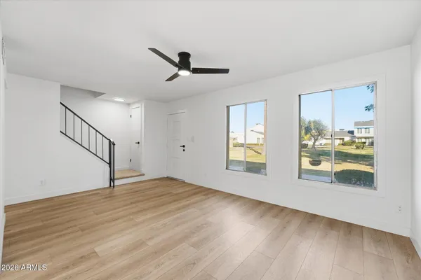 a view of an empty room and wooden floor