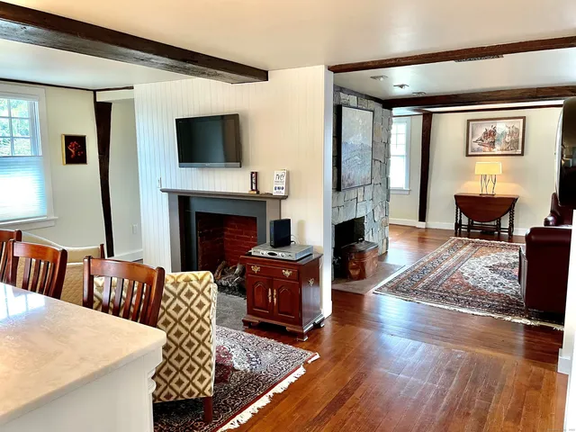 a living room with furniture flat screen tv and a fireplace