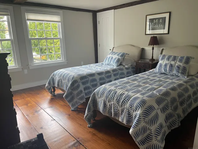 a bedroom with two beds and a window