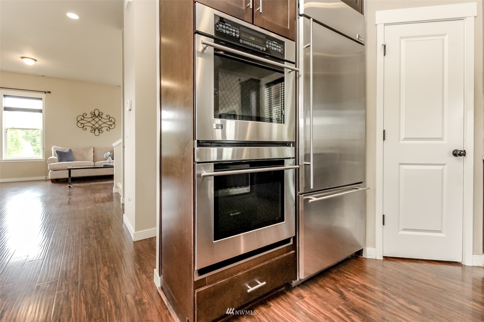 889 Lund Street Buckley, WA 98321 - Photo 12 of 40 a kitchen with a refrigerator and a wooden floor