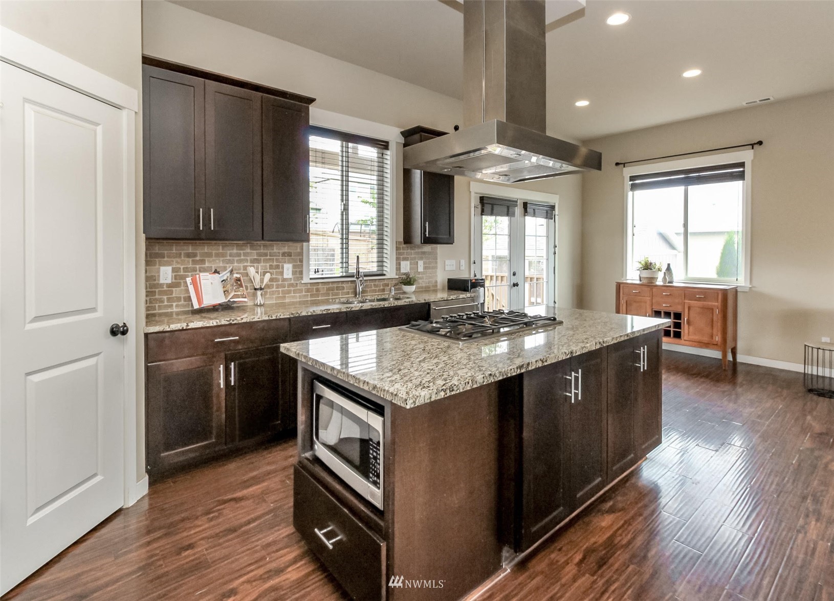 889 Lund Street Buckley, WA 98321 - Photo 13 of 40 a kitchen with granite countertop a sink stove and cabinets