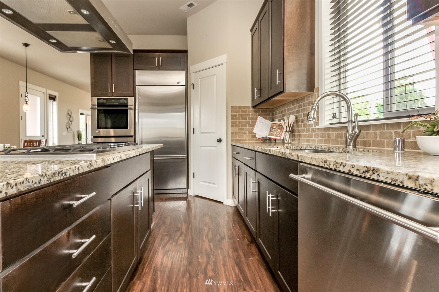 889 Lund Street Buckley, WA 98321 - Photo 15 of 40 a kitchen with stainless steel appliances granite countertop a sink stove and refrigerator