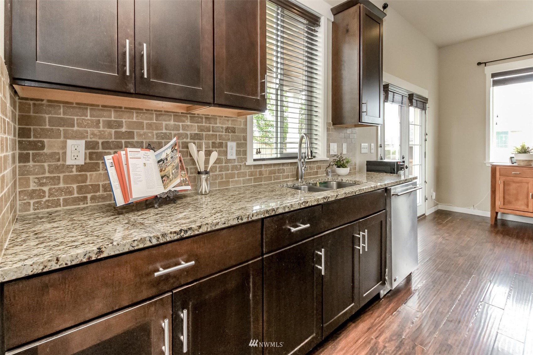 889 Lund Street Buckley, WA 98321 - Photo 16 of 40 a kitchen with granite countertop a sink a stove cabinets and wooden floor