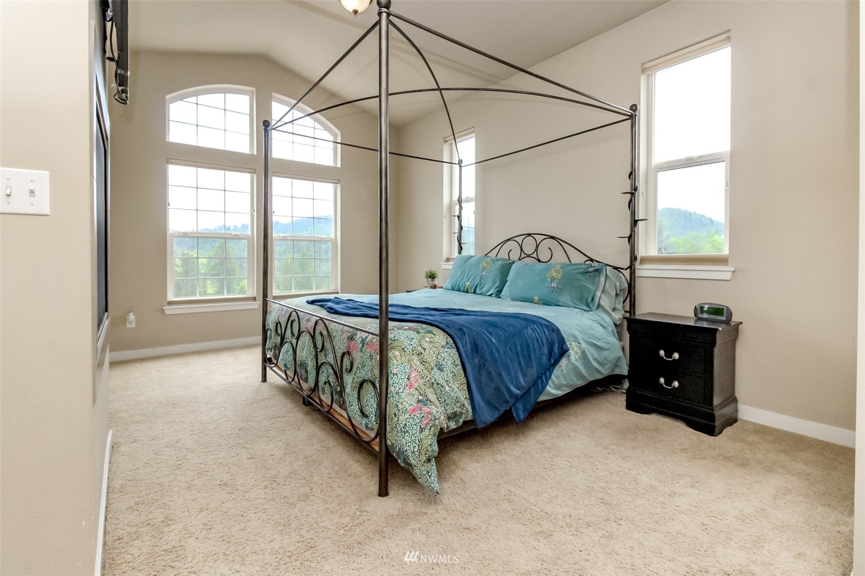 889 Lund Street Buckley, WA 98321 - Photo 25 of 40 a bedroom with a bed and a chandelier