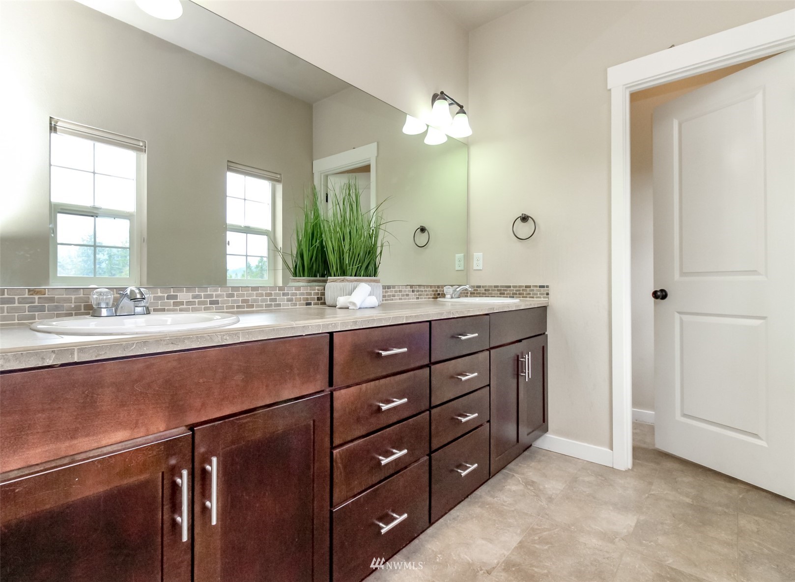889 Lund Street Buckley, WA 98321 - Photo 27 of 40 a bathroom with a granite countertop sink a large mirror a and a window