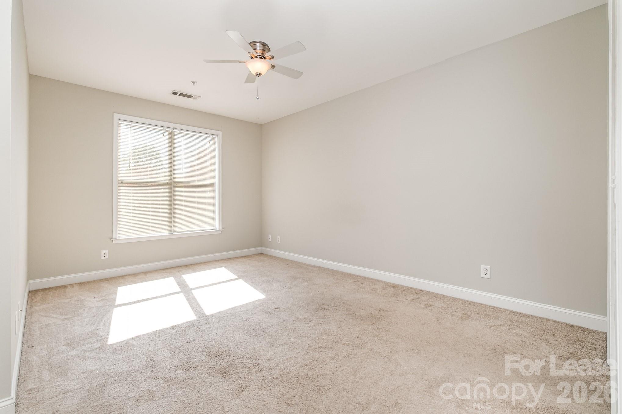 1000 East Woodlawn Road, Unit 201 Charlotte, NC 28209 - Photo 18 of 29 an empty room with a window