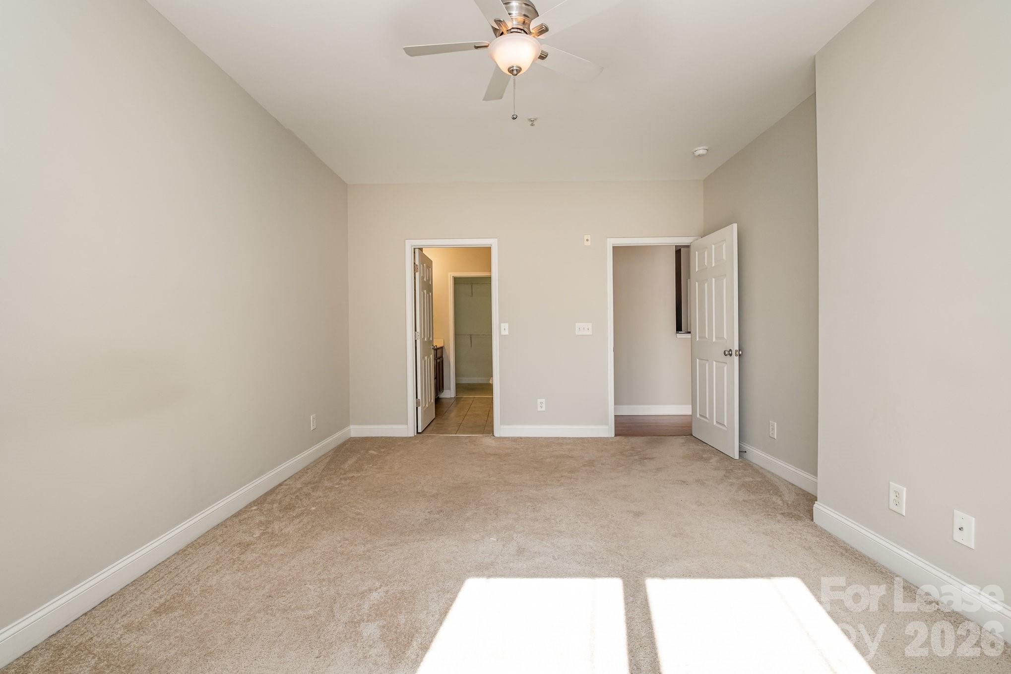 1000 East Woodlawn Road, Unit 201 Charlotte, NC 28209 - Photo 19 of 29 a view of an empty room with a chandelier fan