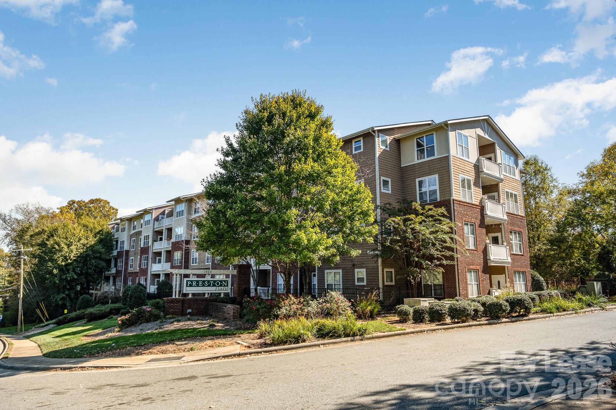 1000 East Woodlawn Road, Unit 201 Charlotte, NC 28209 - Photo 2 of 29 a front view of a building with street view