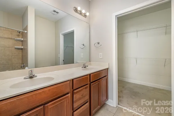 a bathroom with a sink double vanity and a mirror