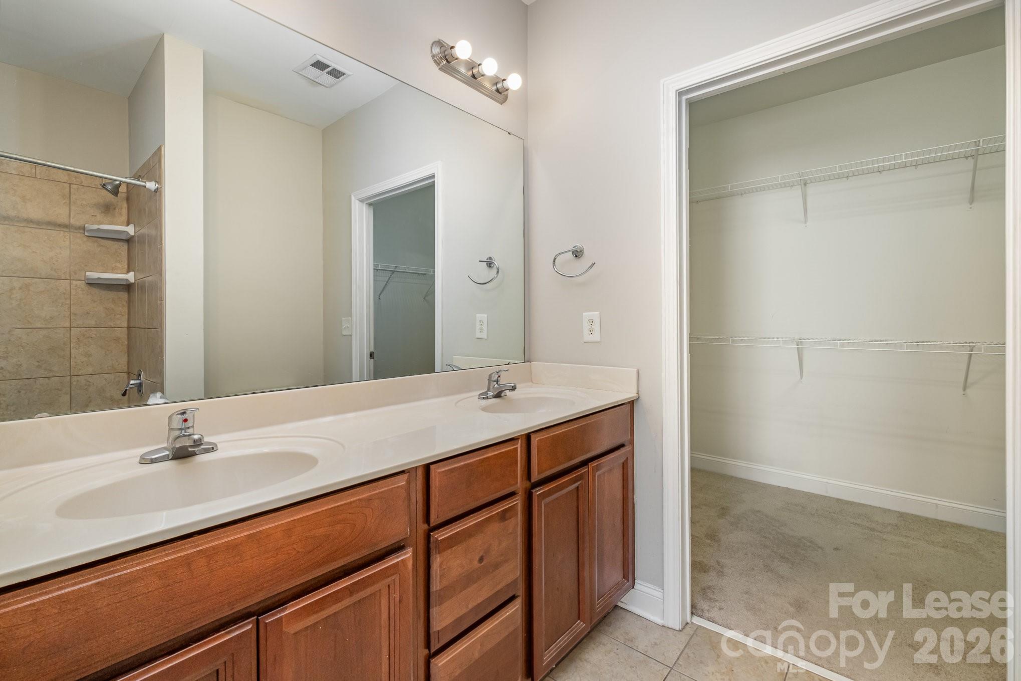 1000 East Woodlawn Road, Unit 201 Charlotte, NC 28209 - Photo 21 of 29 a bathroom with a sink double vanity and a mirror