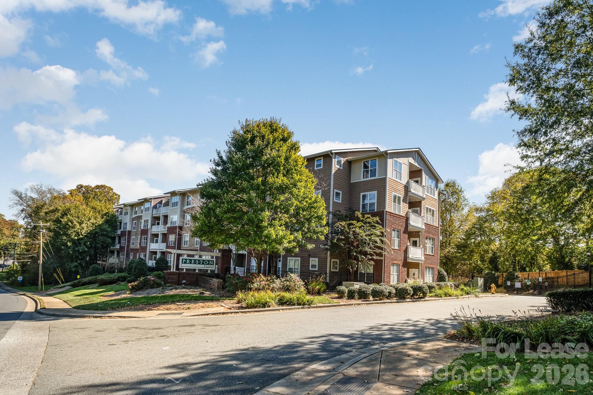 1000 East Woodlawn Road, Unit 201 Charlotte, NC 28209 - Photo 29 of 29 a front view of a house with a yard