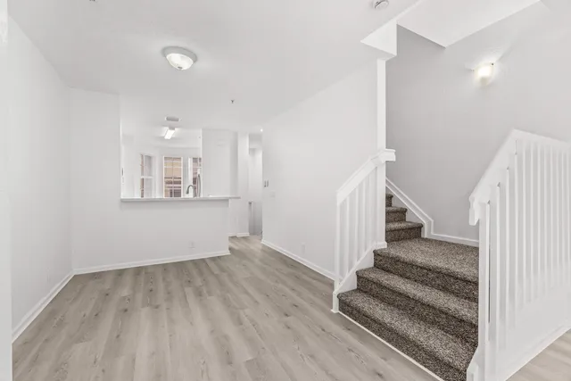 a view of entryway and hall with wooden floor