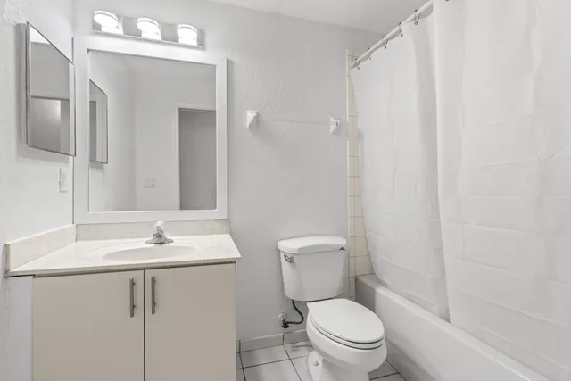 a white toilet sitting next to a bathroom sink