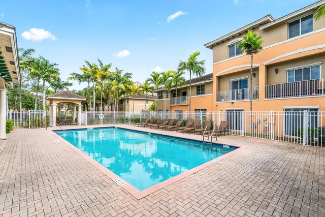 a view of a house with swimming pool and sitting area