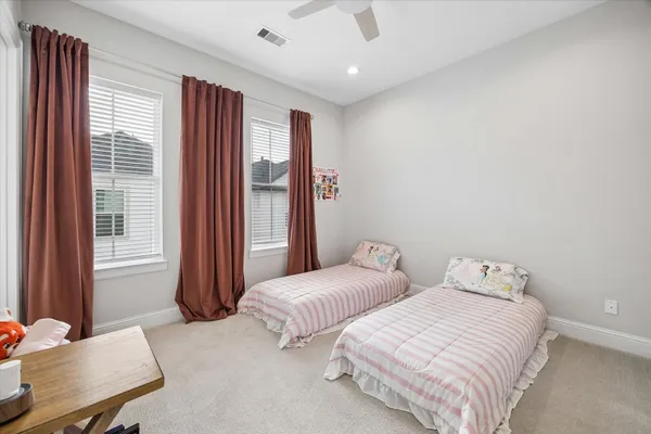 a bedroom with two beds and a window