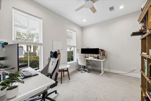 a living room with furniture a window and a flat screen tv