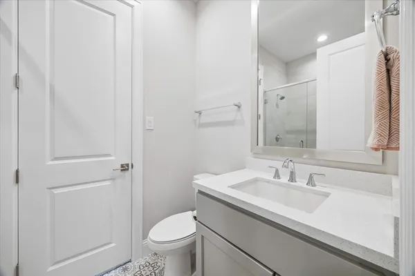 a bathroom with a sink a toilet and a mirror