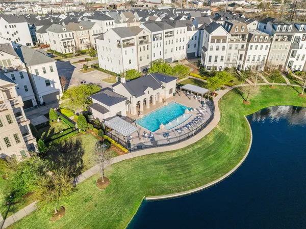 an aerial view of residential house with outdoor space and swimming pool