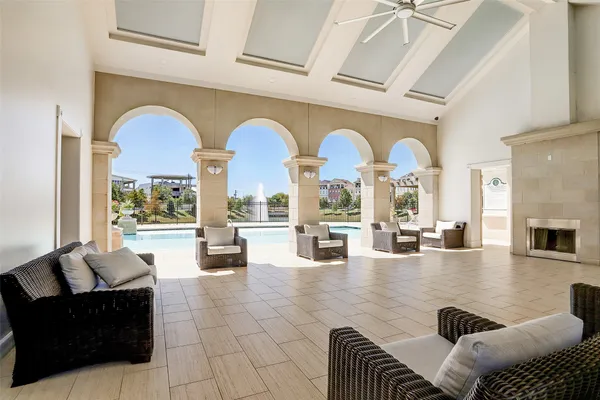 a living room with fireplace furniture and a large window