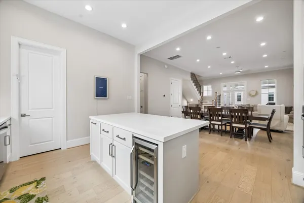 a large white kitchen with table and chairs
