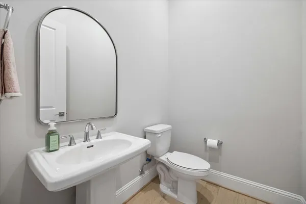 a bathroom with a sink a toilet and mirror