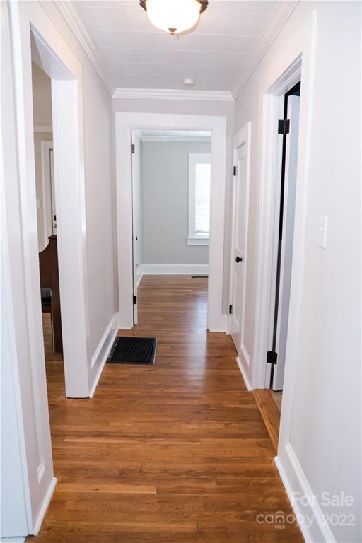 118 Baxter Street Morganton, NC 28655 - Photo 12 of 18 a view of a hallway with wooden floor and staircase