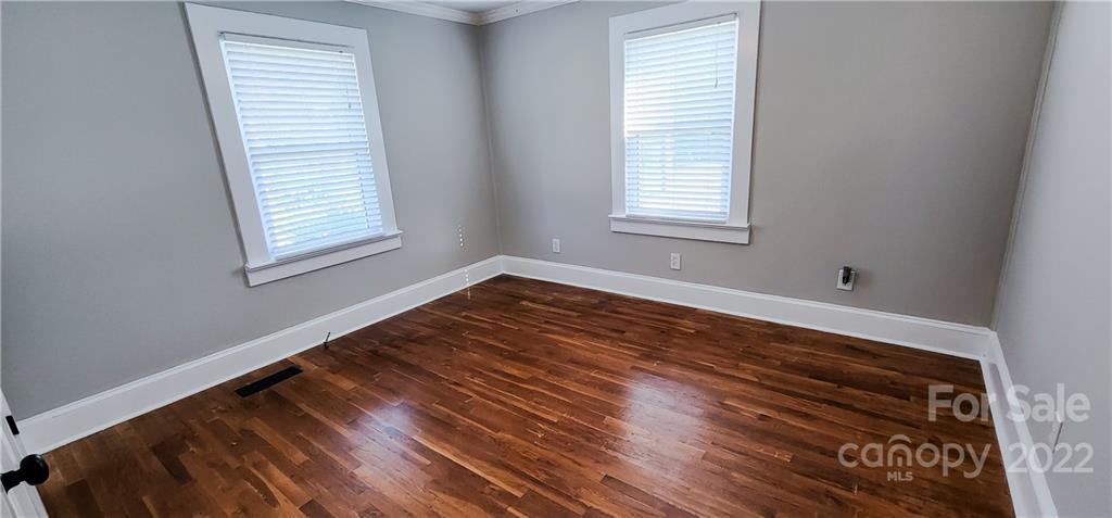 118 Baxter Street Morganton, NC 28655 - Photo 13 of 18 a view of an empty room with wooden floor and a window