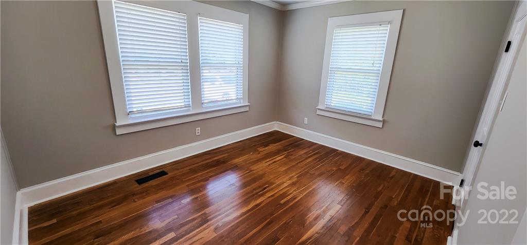 118 Baxter Street Morganton, NC 28655 - Photo 16 of 18 a view of an empty room with wooden floor and a window