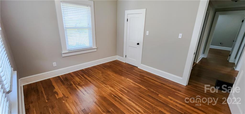 118 Baxter Street Morganton, NC 28655 - Photo 17 of 18 a view of an empty room with wooden floor and a window