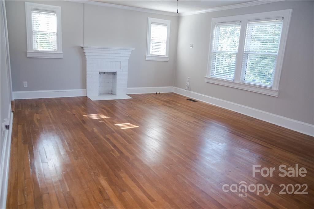 118 Baxter Street Morganton, NC 28655 - Photo 6 of 18 an empty room with wooden floor and windows