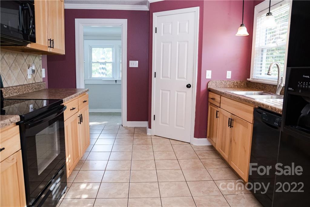 118 Baxter Street Morganton, NC 28655 - Photo 7 of 18 a kitchen with a stove a sink and a microwave