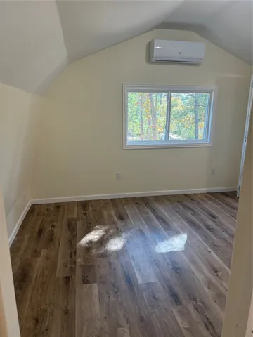 an empty room with wooden floor