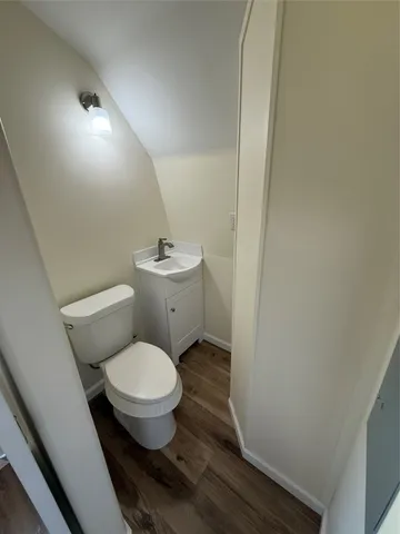 a white toilet sitting next to a small bathroom