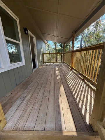 a view of balcony with wooden floor