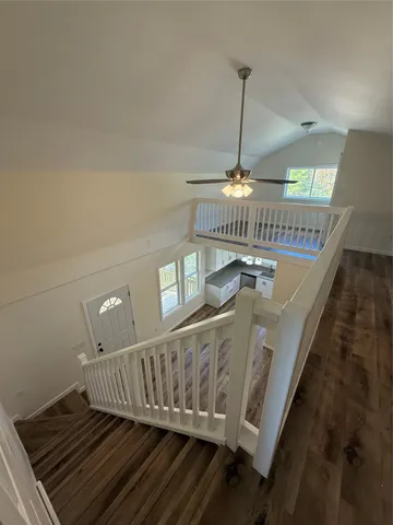 a view of entryway and hall with wooden floor