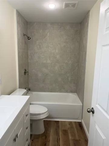 a bathroom with a toilet and a bath tub