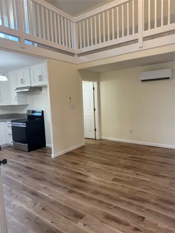 a view of kitchen with cabinets and wooden floor
