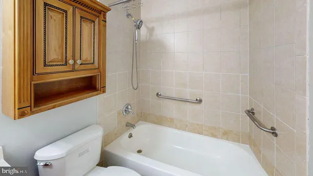 a white bath tub sitting next to a toilet