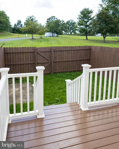 a view of a deck with a big yard