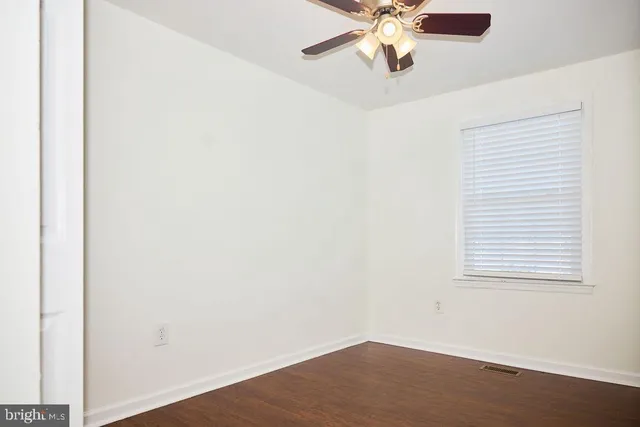 a bathroom with a granite countertop toilet sink and mirror
