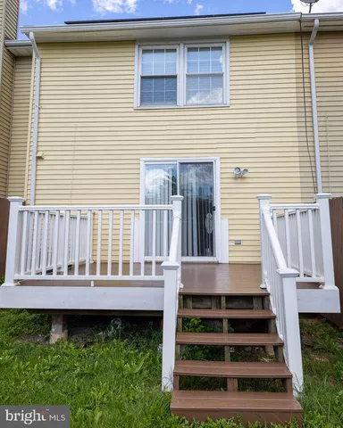 a view of a house with wooden floor and floor to ceiling windows