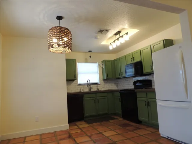 a kitchen with a sink stainless steel appliances and cabinets