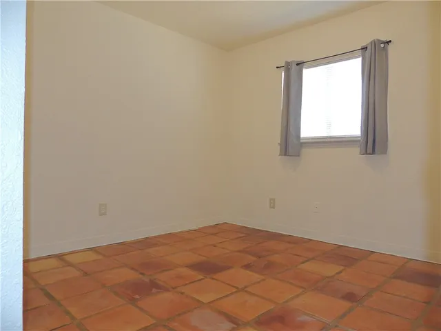 a backyard of a house with a table and chairs