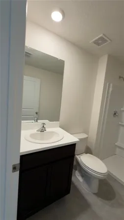 a bathroom with a sink toilet and mirror