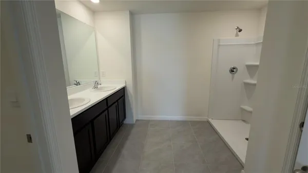 a bathroom with a double vanity sink and mirror