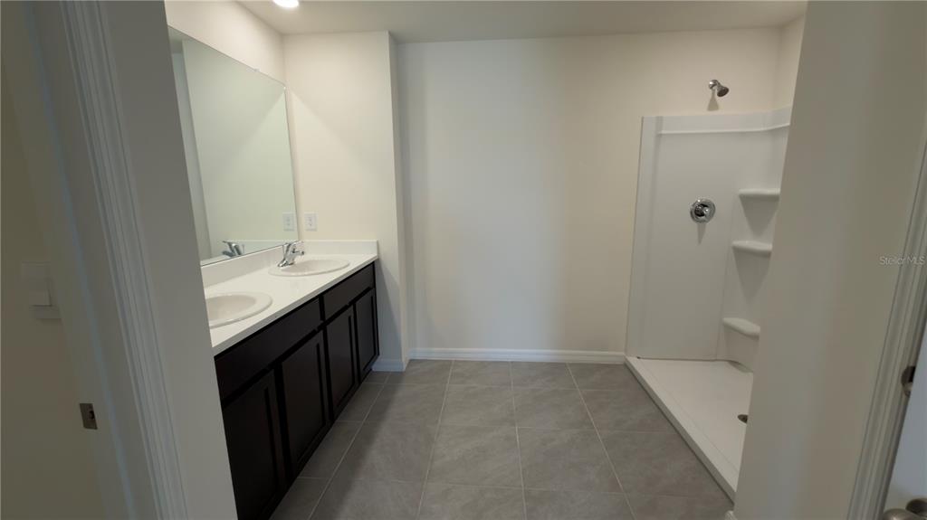 8632 Southwest 45th Court Ocala, FL 34476 - Photo 28 of 41 a bathroom with a double vanity sink and mirror