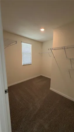 an empty room with a empty space and windows