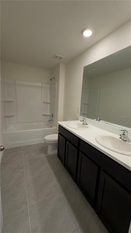 8632 Southwest 45th Court Ocala, FL 34476 - Photo 33 of 41 a bathroom with a double vanity sink a toilet and a mirror
