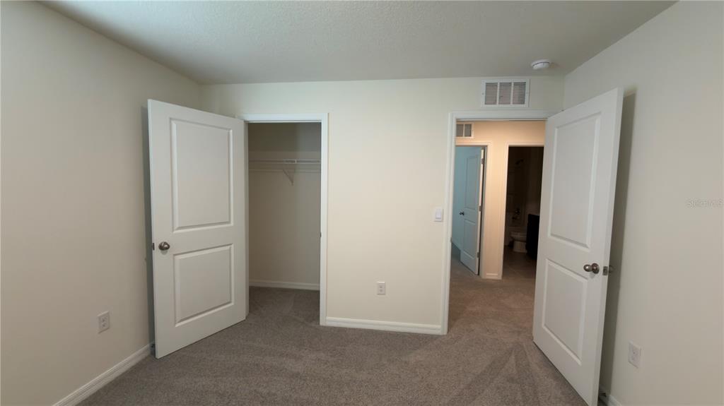 8632 Southwest 45th Court Ocala, FL 34476 - Photo 36 of 41 an empty room with closet and a bathroom